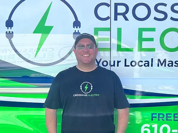 Crosswyre Electric owner standing in front of company van with logo, showcasing local electrical services.